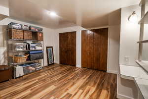 Living area featuring baseboards and wood finished floors