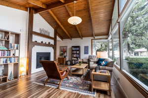 Sunroom featuring beam ceiling