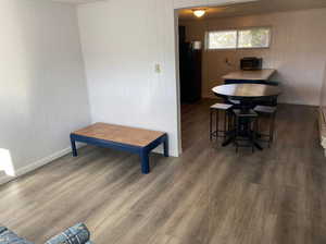 Dining area featuring wooden walls, wood finished floors, and baseboards