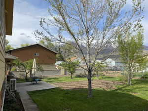 View of yard featuring fence, a patio, and ac unit