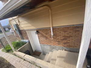 View of exterior entry featuring brick siding
