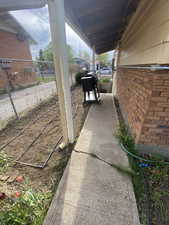Exterior space featuring fence and brick siding