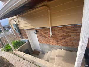 Property entrance featuring brick siding