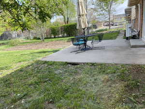 View of yard with a patio and fence