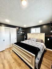 Bedroom featuring light wood-style flooring and a textured ceiling
