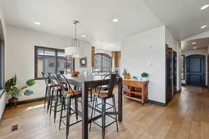 Dining space featuring visible vents, light wood-style floors, a wealth of natural light, and baseboards