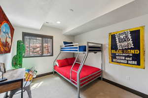 Carpeted bedroom with baseboards, visible vents, and recessed lighting