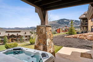 Details with a mountain view, a residential view, and a jacuzzi