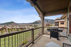 Balcony with a mountain view, area for grilling, and a residential view
