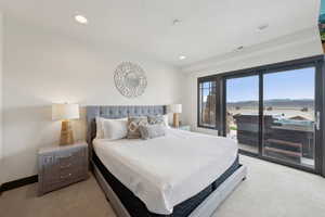 Bedroom with access to outside, visible vents, light carpet, and recessed lighting
