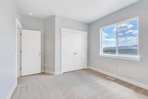 Unfurnished bedroom with baseboards, visible vents, a closet, and carpet