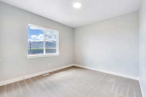 Unfurnished room with visible vents, baseboards, and carpet floors