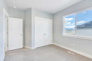 Unfurnished bedroom with baseboards, visible vents, a closet, and carpet flooring