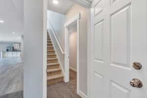 Stairs with recessed lighting, carpet flooring, and baseboards