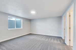 Unfurnished bedroom with baseboards and carpet