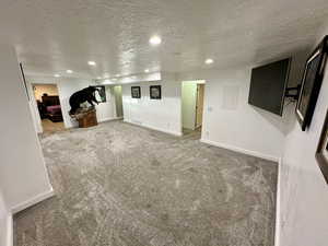 Finished below grade area featuring recessed lighting, carpet flooring, and baseboards