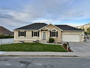 Single story home with a front yard, a garage, stucco siding, and fence