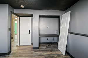 Entrance foyer featuring baseboards and wood finished floors