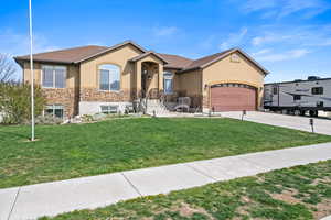 View of front of home with an attached garage, concrete driveway, stone siding, and stucco siding