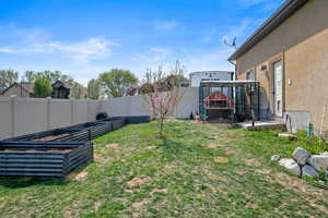 View of yard featuring a vegetable garden and a fenced backyard