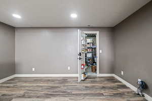 Basement with recessed lighting, visible vents, wood finished floors, and baseboards
