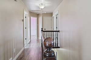 Corridor featuring hardwood / wood-style flooring and baseboards