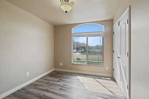 Interior space with baseboards, visible vents, wood finished floors, and a closet