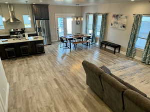 Living room featuring baseboards, recessed lighting, and light wood-style floors