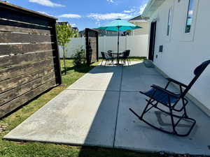 View of patio with a fenced backyard and outdoor dining area