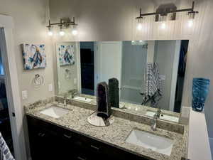 Full bathroom with a sink, a walk in shower, and double vanity