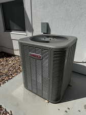 Details featuring stucco siding and cooling unit