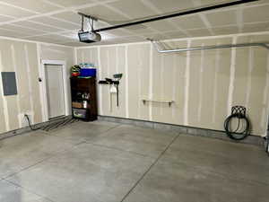 Garage with a garage door opener and electric panel