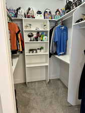 Walk in closet featuring carpet