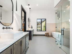 Primary bathroom with double vanities, and freestanding tub