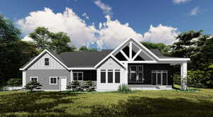 Rear view of property with board and batten siding and a lawn