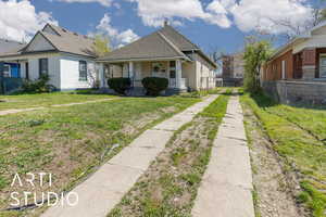 Bungalow-style home featuring fence, driveway, a porch, roof with shingles, and a front yard