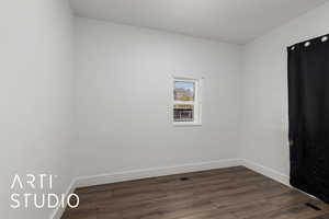 Unfurnished bedroom #3  with baseboards and dark wood-style floors, windows and closet