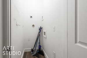 Interior space with laundry area, wood finished floors, hookup for an electric dryer, hookup for a washing machine, and baseboards