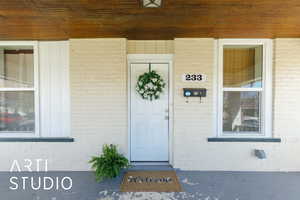 Doorway to property with brick siding