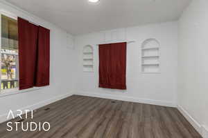 Bedroom #1 with  wood style flooring, built in shelves,  closet, windows and baseboards