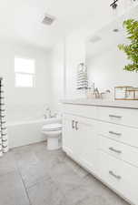 Full bath featuring visible vents, toilet, a bathtub, and vanity