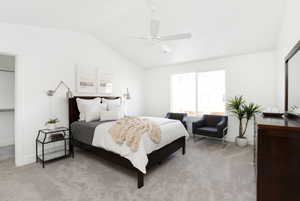 Bedroom with lofted ceiling, ceiling fan, baseboards, and light carpet