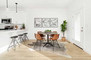 Dining space featuring light wood finished floors and baseboards