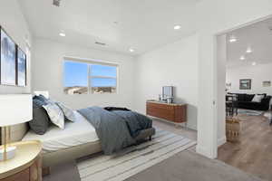 Bedroom with recessed lighting, visible vents, wood finished floors, and baseboards