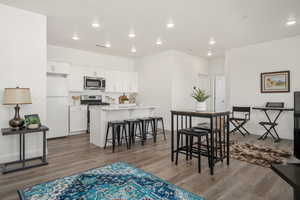 Dining space featuring wood finished floors, recessed lighting, and baseboards