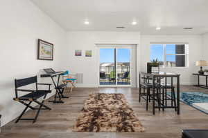 Interior space featuring wood finished floors, visible vents, and baseboards