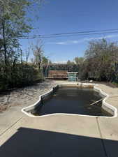 View of swimming pool with a fenced in pool and fence