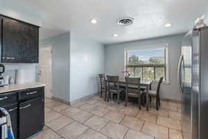 Dining area featuring light tile patterned floors, recessed lighting, and baseboards