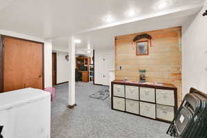 Interior space featuring white refrigerator, carpet, and recessed lighting
