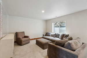 Living room with recessed lighting, visible vents, carpet floors, and baseboards